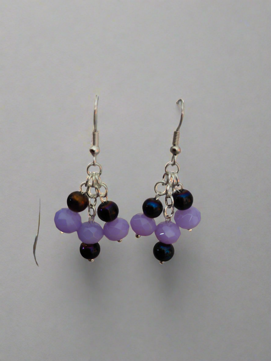 Chandelier Earrings with Purple Glass Beads - Premium Earrings from ZeesPieces - Just $20! Shop now at Zee's Pieces. Gorgeous chandelier earrings with light lavender and dark purple glass beads from Zee’s Pieces, featuring faceted rondelle shapes and silver-toned metal components, perfect for adding elegance and sophistication to any outfit, ideal for both casual and formal occasions. Beaded earrings. Handcrafted jewelry. Gift ideas for women. Unique design.