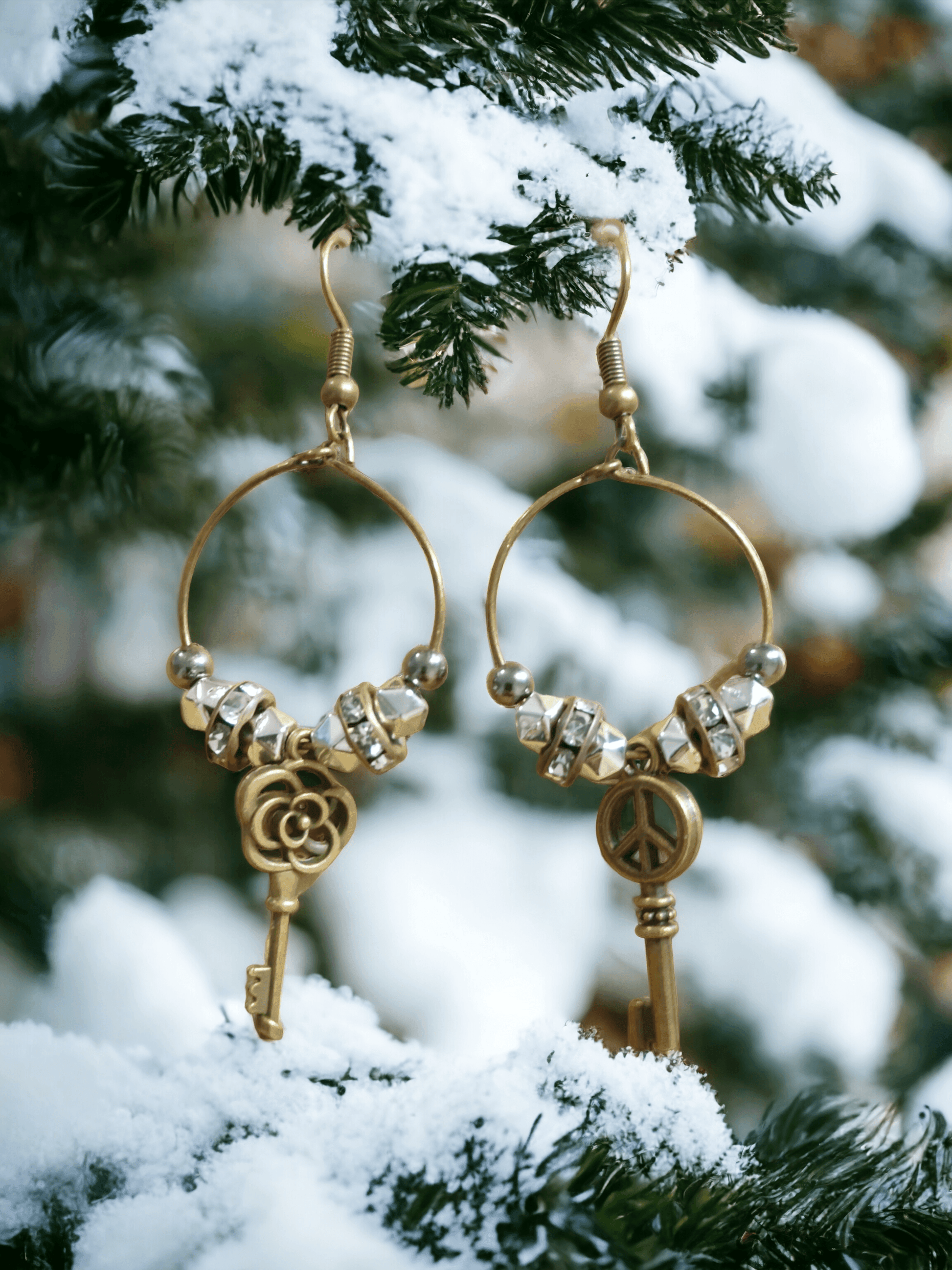 Unique earrings with bronze-colored hoops, round beads, rhinestone rounds, and key-shaped pendants from Zee’s Pieces, featuring distinct key designs, perfect for adding charm and individuality to any outfit, ideal for both casual and formal occasions. Only $15.00. 