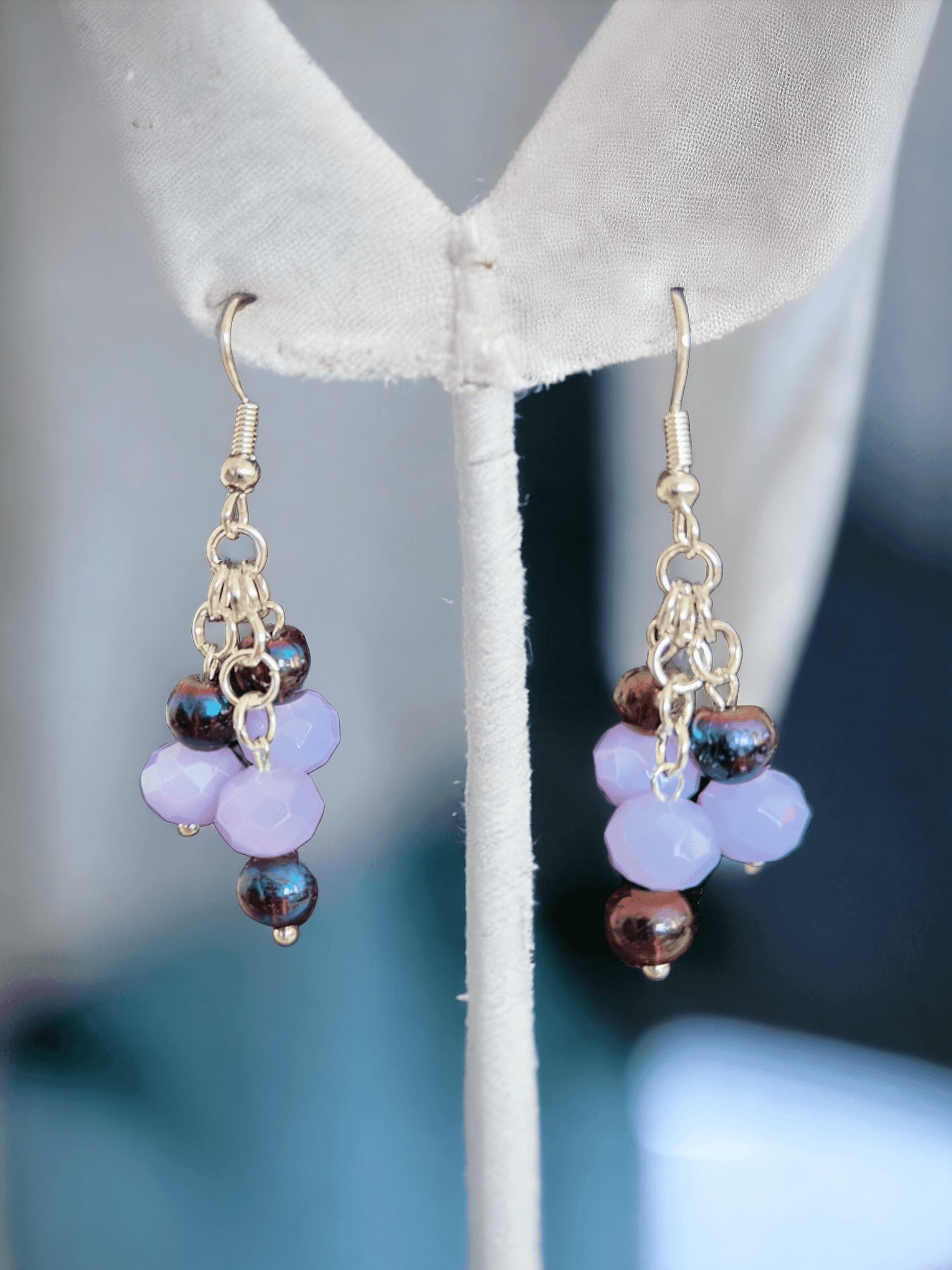 Gorgeous chandelier earrings with light lavender and dark purple glass beads from Zee’s Pieces, featuring faceted rondelle shapes and silver-toned metal components, perfect for adding elegance and sophistication to any outfit, ideal for both casual and formal occasions. Beaded earrings. Handcrafted jewelry. Gift ideas for women. Unique design.