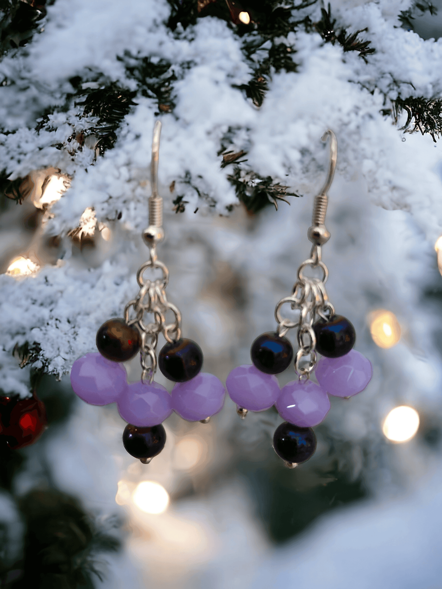 Gorgeous chandelier earrings with light lavender and dark purple glass beads from Zee’s Pieces, featuring faceted rondelle shapes and silver-toned metal components, perfect for adding elegance and sophistication to any outfit, ideal for both casual and formal occasions. Beaded earrings. Handcrafted jewelry. Gift ideas for women. Unique design.