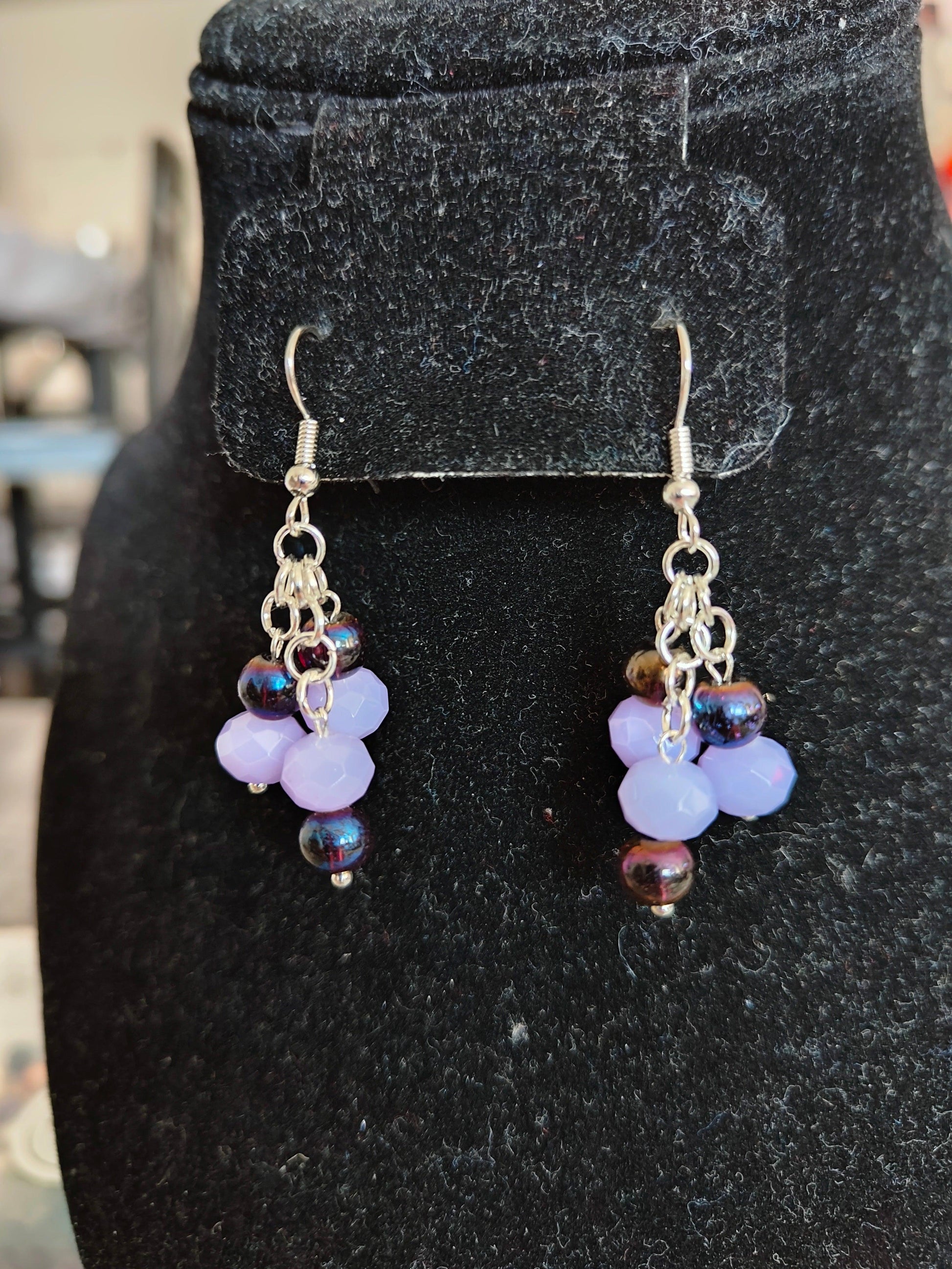 Gorgeous chandelier earrings with light lavender and dark purple glass beads from Zee’s Pieces, featuring faceted rondelle shapes and silver-toned metal components, perfect for adding elegance and sophistication to any outfit, ideal for both casual and formal occasions. Beaded earrings. Handcrafted jewelry. Gift ideas for women. Unique design.